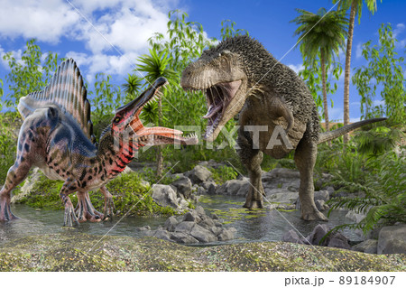 スピノサウルスと毛の生えたティラノサウルスが植物が生い茂る水辺で対峙しにらみ合い縄張り争いをする 89184907
