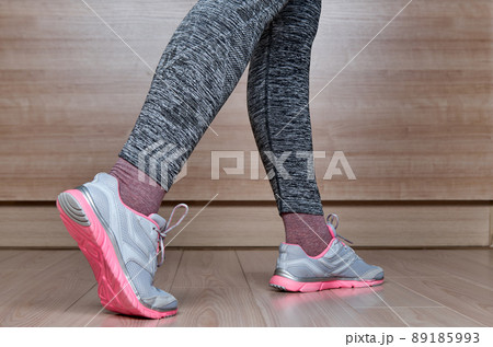 Fit female leg in sport shoe step 89185993
