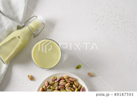 Pistachio milk in glass, lactose free. Vegan plant based milk. Pistachio milk in glass, lactose free. Vegan plant based milk. 89187503