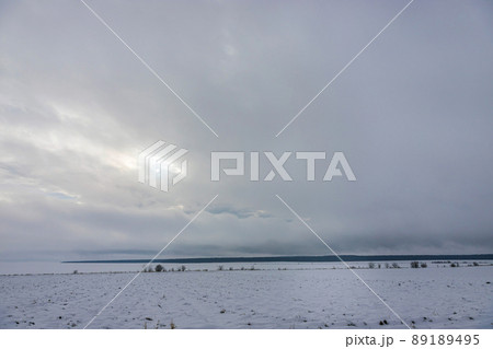 Natural sunset sunrise over field or meadow. The color of the sky over the winter snowy ground. Landscape under a picturesque sky at sunset. Dawn of the sun. Natural sunset sunrise over field or meadow. The color of the sky over the winter snowy ground. Landscape under a picturesque sky at sunset. Dawn of the sun. 89189495