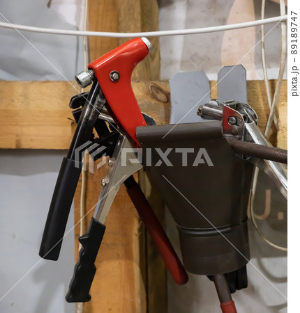 tools in the workshop drills, screwdrivers, scissors on the metal, on the shelf tools in the workshop drills, screwdrivers, scissors on the metal, on the shelf 89189747