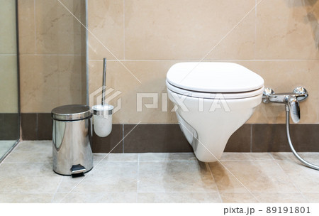 White toilet bowl in a modern bathroom with shower 89191801