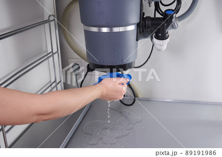 Waste disposal leak under a sink, broken garbage chopper 89191986