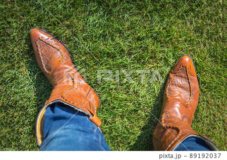 Person wearing jeans and cowboy boots, view from above 89192037