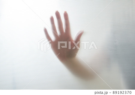 Diffused silhouette of female hands through plastic 89192370