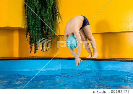 Boy swimming in indoor pool having fun during swim class Boy swimming in indoor pool having fun during swim class 89192475