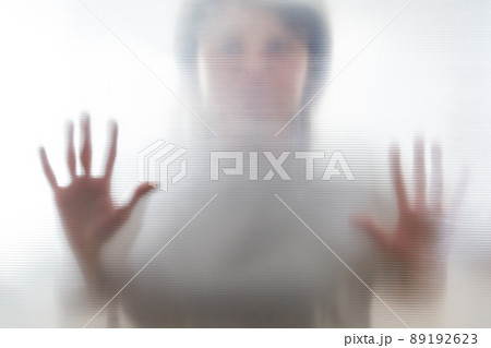 Diffused silhouette of female hands, view with shadow through plastic 89192623