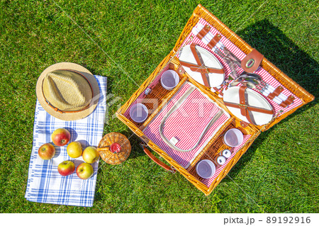 Picnic basket on green sunny lawn in the park 89192916