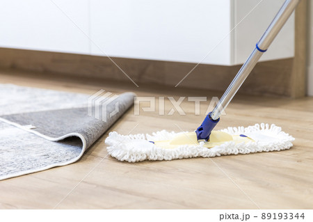 Wooden floor with white mop, cleaning service concept 89193344