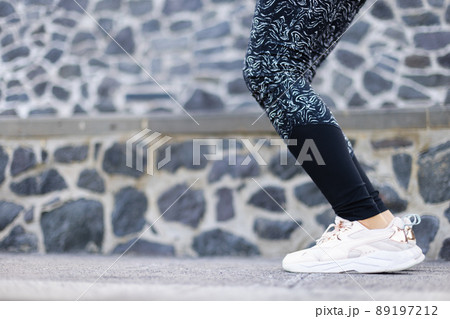 Woman in sport clothes is ready for jumping. Female legs in leggings. Woman in sport clothes is ready for jumping. Female legs in leggings. 89197212