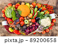 A lot of fruits, vegetables and berries sprinkled on a wooden background in the form of a frame. 89200658