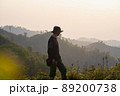 silhouette hiker man relax on mountain with sunset background 89200738