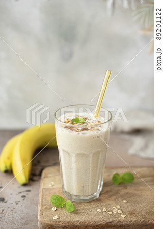 banana milkshake with oatmeal and cinnamon in a glass 89201122