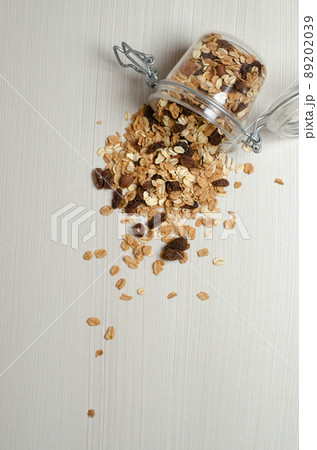 Oatmeal with nuts and raisins. Scattered on the table. Flat lay 89202039