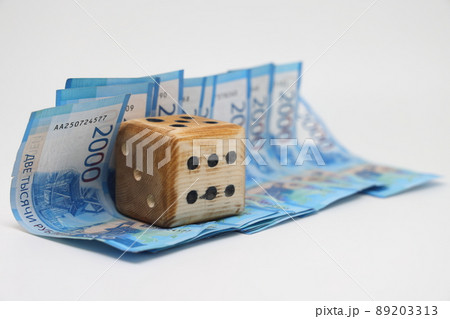 Homemade dice lies on Russian banknotes, unpredictability of financial markets. 89203313