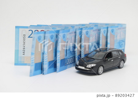Toy car on the background of banknotes, purchase, insurance and the cost of car ownership. Toy car on the background of banknotes, purchase, insurance and the cost of car ownership. 89203427