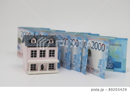 toy house on banknotes, buying your own home, mortgage, symbol of material well being. 89203429
