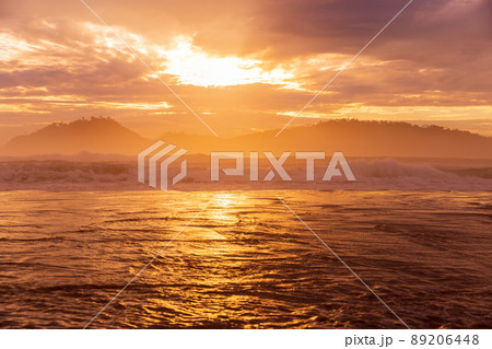 Sunrise with clouds and silhouette of Campeche island in Florianopolis 89206448