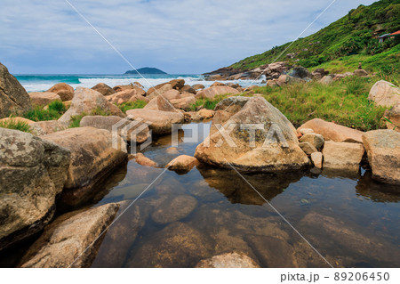 Coastline with river, stones and ocean with waves in Brazil, Florianopolis Coastline with river, stones and ocean with waves in Brazil, Florianopolis 89206450