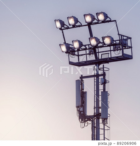 Stadium lights on the sunset sky background. Stadium lights on the sunset sky background. 89206906