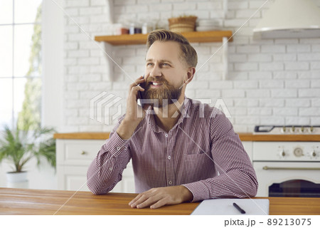 Smiling man talk on smartphone gadget Smiling man talk on smartphone gadget 89213075
