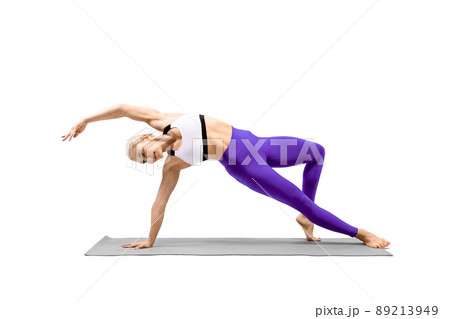 Balance and stretching yoga. Attractive fit woman in sportswear practice Camatkarasana exercise, wild thing, isolated on white. Balance and stretching yoga. Attractive fit woman in sportswear practice Camatkarasana exercise, wild thing, isolated on white. 89213949