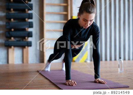 Fit woman doing full plank exercise works on abdominal muscles Fit woman doing full plank exercise works on abdominal muscles 89214549