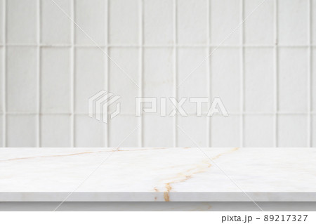 Empty white marble table top with blur tile wall bathroom background 89217327