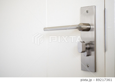 Modern door handle with on white door 89217361