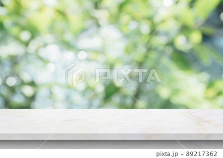 Marble table top with blur green leaf bokeh nature background 89217362