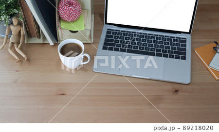 From above view simple workplace with computer laptop, coffee cup and supplies. 89218020