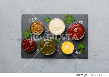 Many different sauces and herbs on table, flat lay top view. sauces on plate, healthy concept Many different sauces and herbs on table, flat lay top view. sauces on plate, healthy concept 89221425