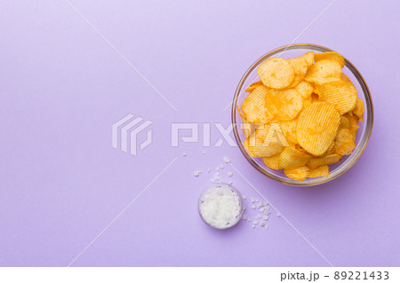 potato chip with salt on colored background top view with copy space potato chip with salt on colored background top view with copy space 89221433