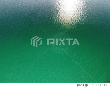 Aerial panoramic view of seascape with crystal clear azure sea and rocky shores. Yachts in a beautiful lagoon on backdrop of rocks. The concept of an ideal destination for summer travel and vacation. 89224249