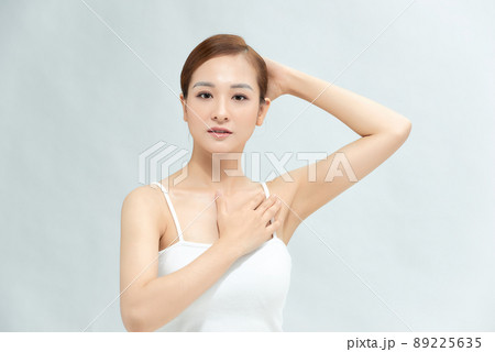 Close-up of a beautiful young woman showing her smooth armpit isolated on white background Close-up of a beautiful young woman showing her smooth armpit isolated on white background 89225635