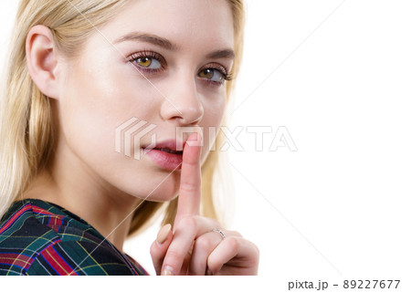 Woman showing silence gesture Woman showing silence gesture 89227677