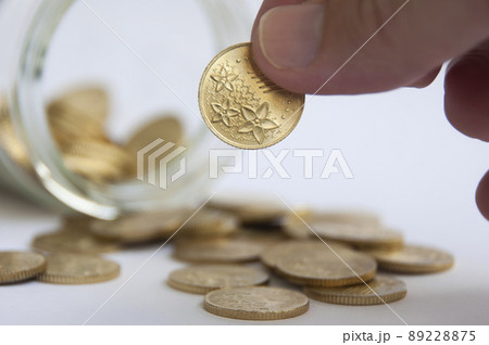 Hand holding gold coin. Business and copy space concept 89228875
