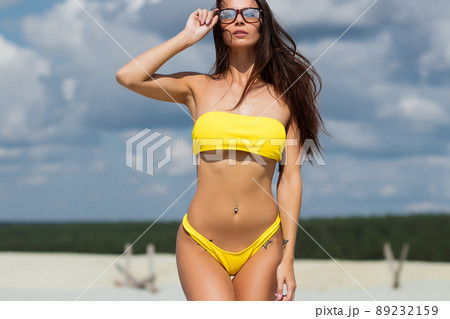 Beautiful woman in swimsuit on beach Beautiful woman in swimsuit on beach 89232159