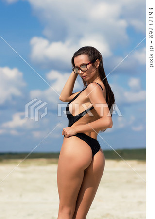 Beautiful woman in swimsuit on beach 89232193