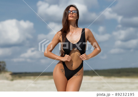 Beautiful woman in swimsuit on beach Beautiful woman in swimsuit on beach 89232195