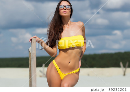 Beautiful woman in swimsuit on beach Beautiful woman in swimsuit on beach 89232201