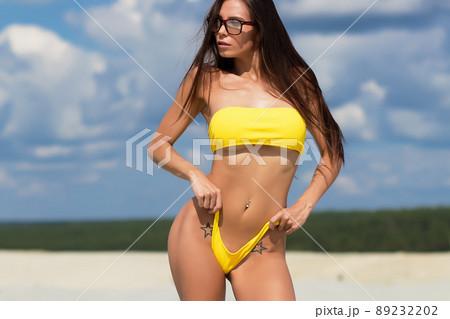 Beautiful woman in swimsuit on beach Beautiful woman in swimsuit on beach 89232202