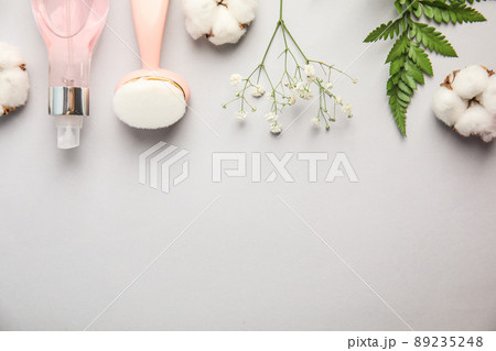 Flat lay composition with face cleansing brush on light grey background. Cosmetic accessory 89235248