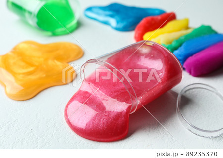 Different bright slimes on white background, closeup 89235370