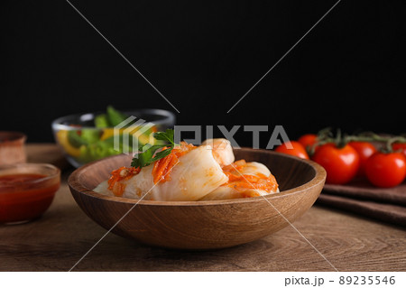 Delicious cabbage rolls served on wooden table against black background 89235546