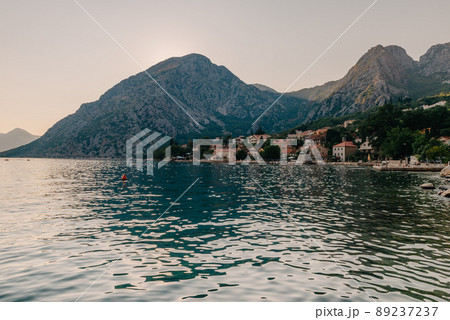 Sunset, beautiful landscape with silhouettes of trees. Travel concept. Montenegro, Kotor Bay. Sunset at Kotor Bay Montenegro. View of the sunset in Boko-Kotor Bay in Montenegro. Silhouettes of 89237237