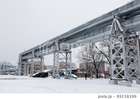 Huge gas pipeline laid along snowy street in Riga, Latvia 89238399