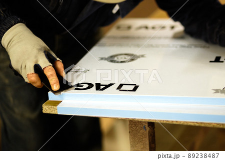 Woodwork and furniture making concept. A carpenter in the workshop doing joinery 89238487