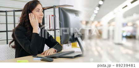 Business people wearing headset working in office broaden view Business people wearing headset working in office broaden view 89239481