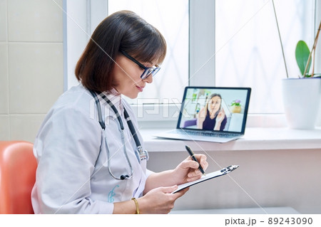 General practitioner doctor talking on videoconference with female patient 89243090
